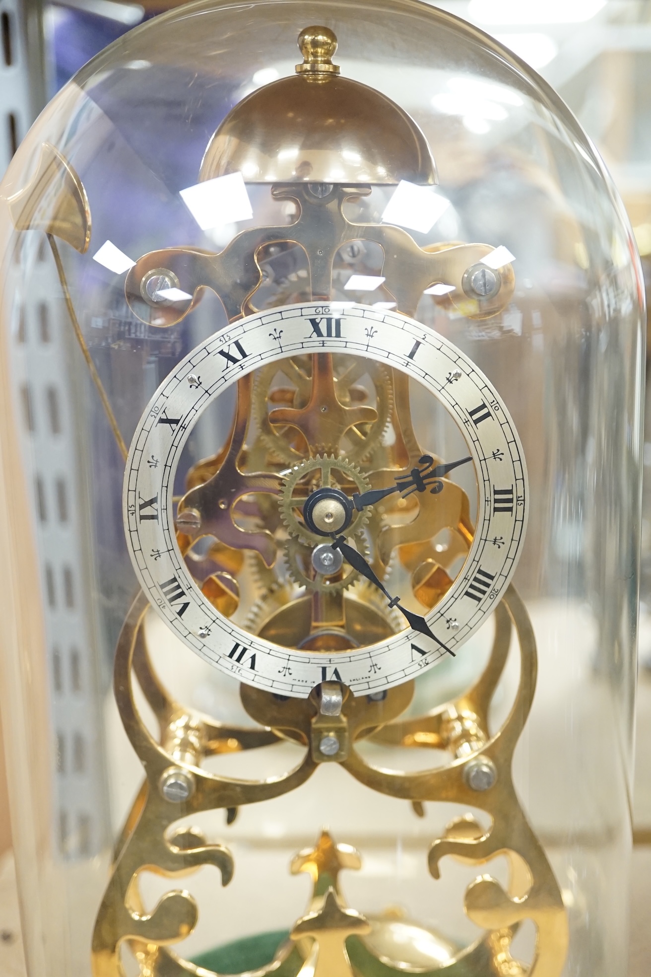 A Thwaites & Reed brass skeleton clock under dome, on onyx base, 27cm. Condition - good, not tested